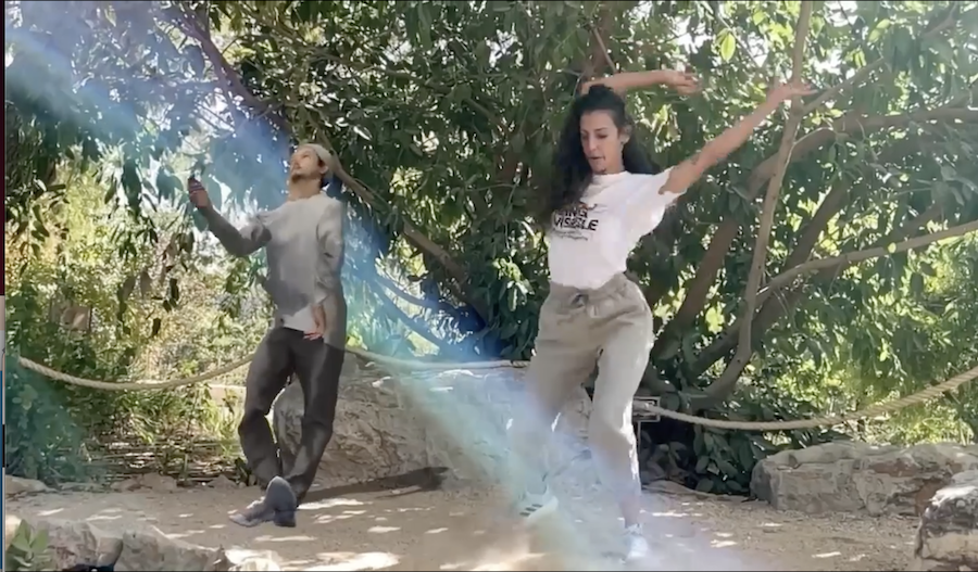 A real world dancer at Jerusalem Botanical Gardens dancing alongside Daito Manabe's Morphecore Prototype AR.